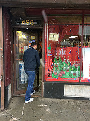 Polemost Liquor clerk Thomas Dunne salts the entryway of this business. Photo by Neil Giardino.