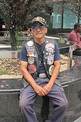 Jose Colon, who honors the 9/11 anniversary every year, wearing a vest he put together to honor and remember the event while downtown on Sept. 11, 2015. Photo by Karis Rogerson