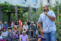 Ray Figueroa, president of the NYC Community Gardens Coalition, addressing the crowd assembled to mourn the passing of Adam Purple, urban gardener and activist. Photo by Diego Lynch