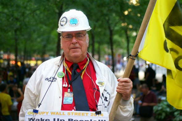 Chuck Helms, a member of International Brotherhood of Electrical Workers. He was covered in pro-union ephemera, including the flag, buttons, and embroidery on his clothing. He had been attending Occupy Wall Street since September of 2011, and now comes to Zuccotti Park every Friday. Photo by Diego Lynch