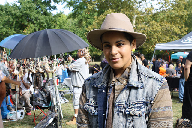 Skye Cabrera, 26, stands in front of a collection of dream catchers at the festival. Photo by Wyatt Salsbury