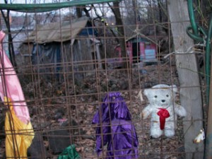 A decorated fence in front of makeshift homes in the Palisades. (photo by Darren Tobia)