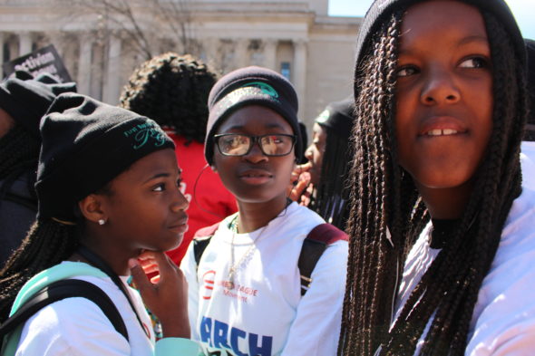 Three young girls participating in March for Our Lives